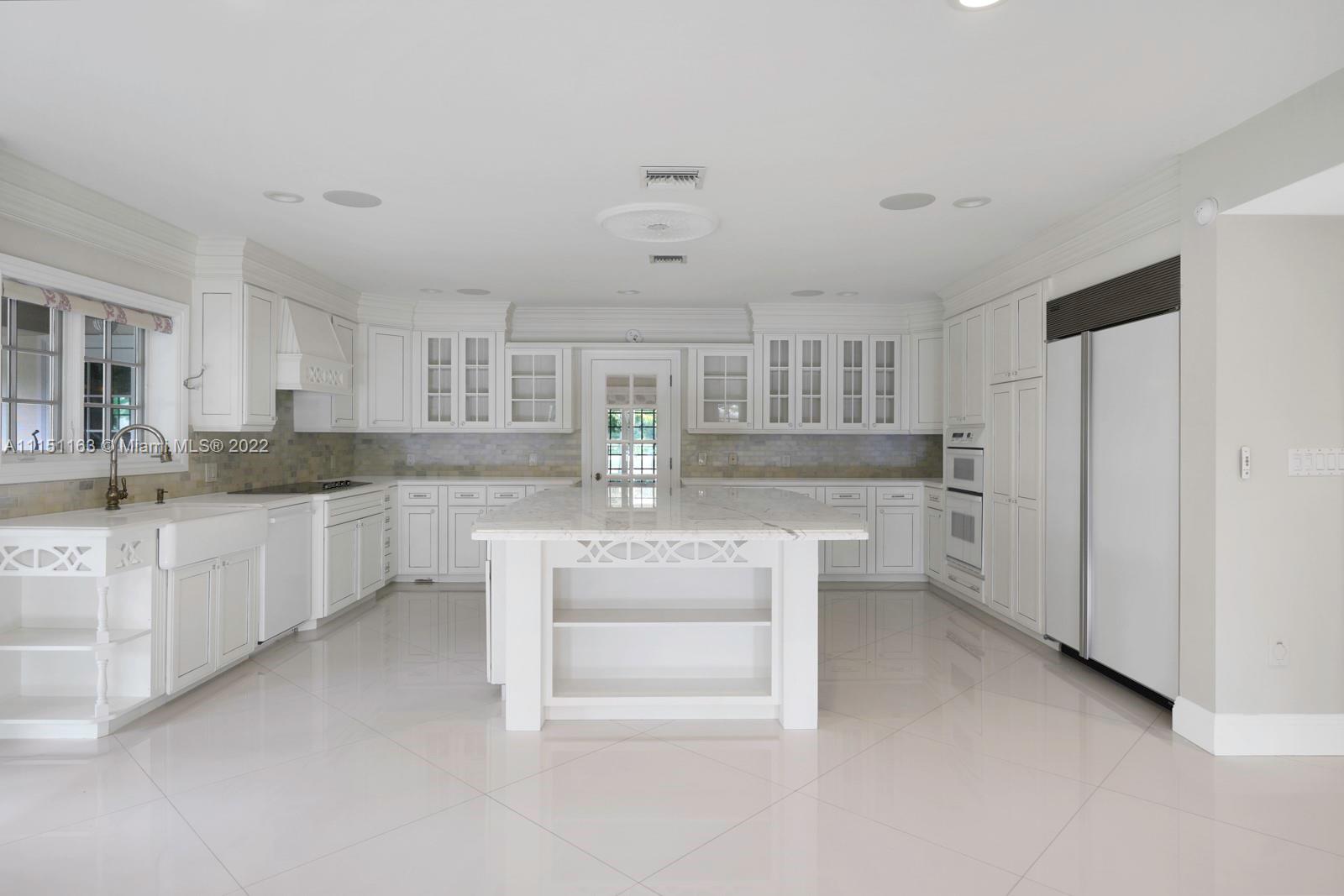 13920 Stirling Road Southwest Ranches, FL 33330 - Photo 28 of 98 a kitchen with white cabinets and refrigerator