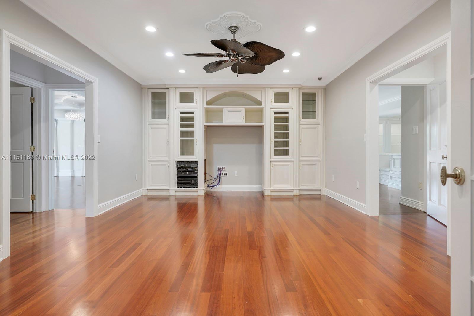 13920 Stirling Road Southwest Ranches, FL 33330 - Photo 61 of 98 a view of empty room with wooden floor and ceiling fan