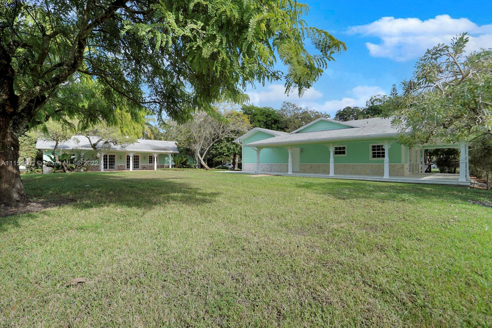 13920 Stirling Road Southwest Ranches, FL 33330 - Photo 82 of 98 a front view of a house with a garden