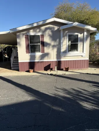 a view of the house with a yard
