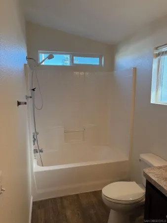 a bathroom with a toilet and a bath tub