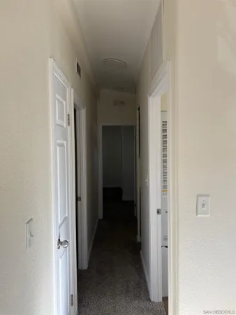 a view of a hallway with a white walls
