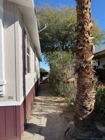 a view of a pathway of a house with a yard