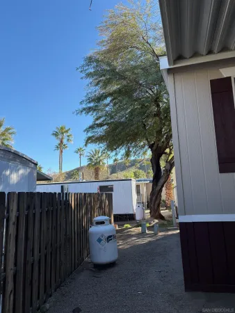 a backyard of a house with table and chairs