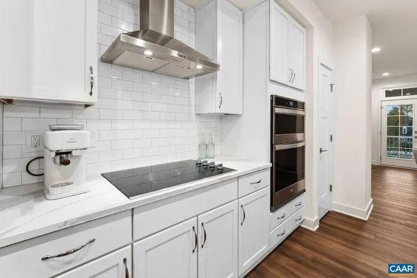 a kitchen with stainless steel appliances a refrigerator and a stove top oven