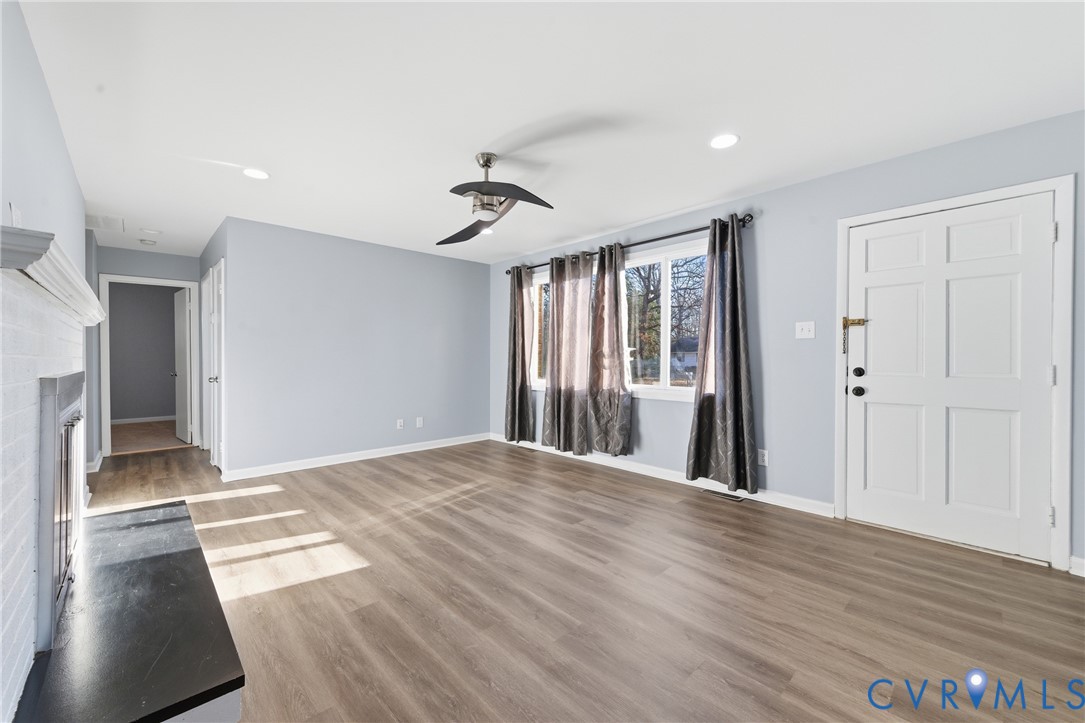 11008 Ryall Road Glen Allen, VA 23059 - Photo 4 of 25 a view of a livingroom with wooden floor and a ceiling fan