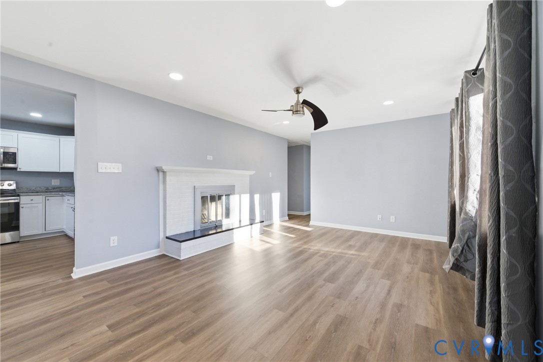 11008 Ryall Road Glen Allen, VA 23059 - Photo 5 of 25 a view of an empty room with wooden floor and a window