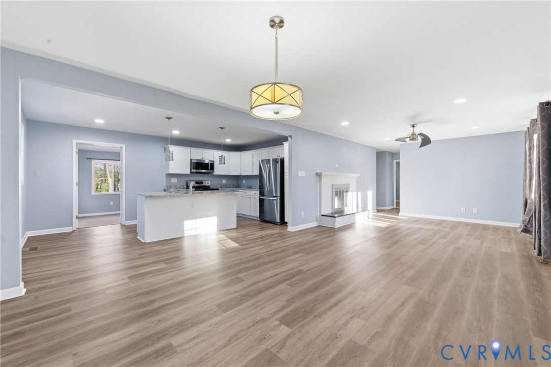 11008 Ryall Road Glen Allen, VA 23059 - Photo 8 of 25 a view of an empty room and kitchen with wooden floor
