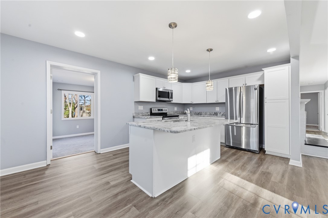 11008 Ryall Road Glen Allen, VA 23059 - Photo 9 of 25 a kitchen with stainless steel appliances granite countertop a refrigerator a sink dishwasher a stove top oven a refrigerator and white cabinets with wooden floor