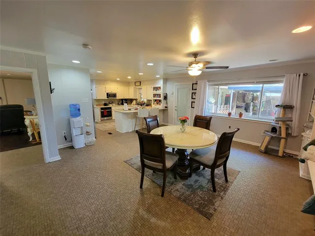 a view of a dining room with furniture and a window