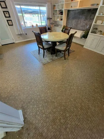 a large kitchen with a table and chairs