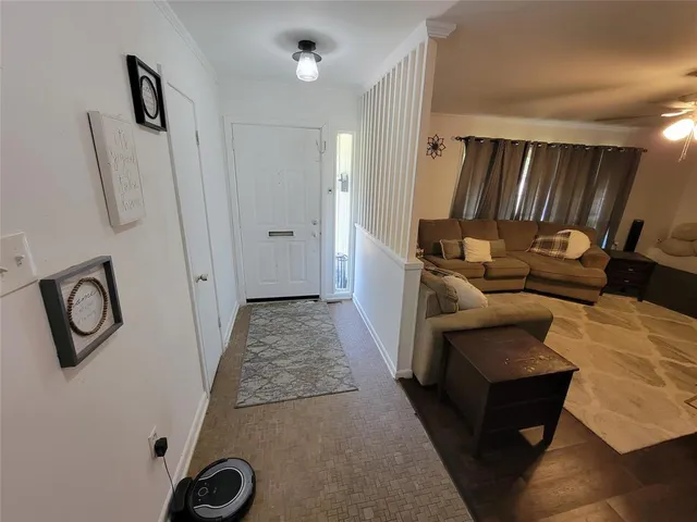 a living room with furniture and a ceiling fan