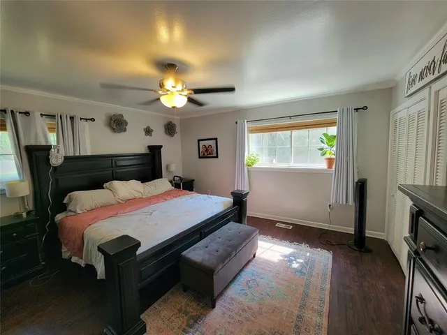 a bed room with a bed window and table chair