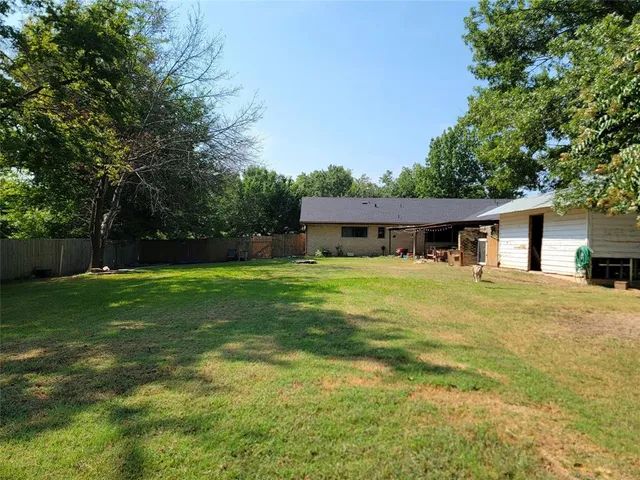 a backyard of a house with plants and garden