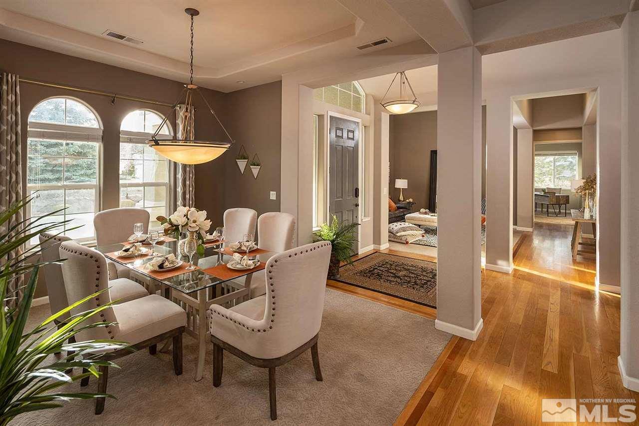 5278 North Elk River Road Reno, NV 89511 - Photo 15 of 30 a dining room with furniture a chandelier and wooden floor