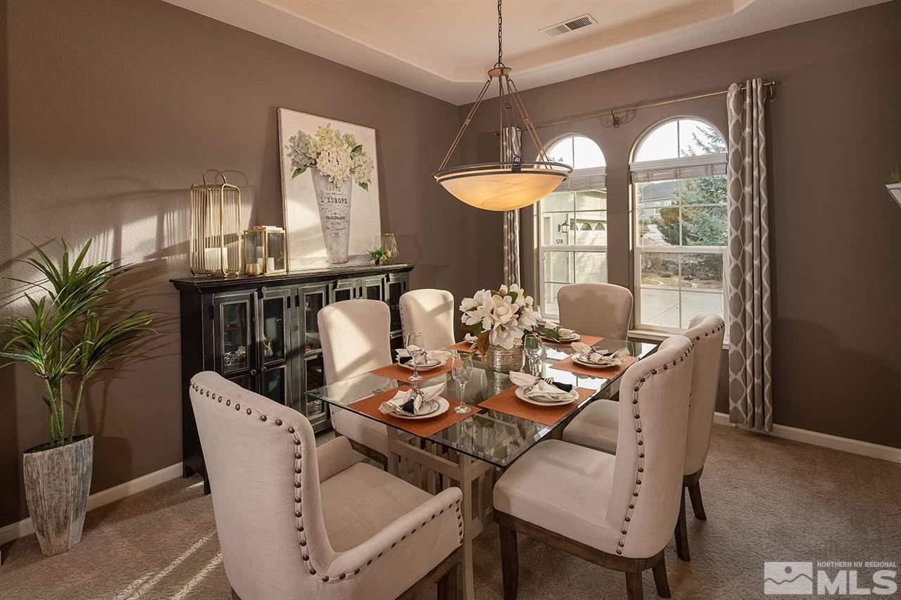 5278 North Elk River Road Reno, NV 89511 - Photo 16 of 30 a dining room with furniture a chandelier and window