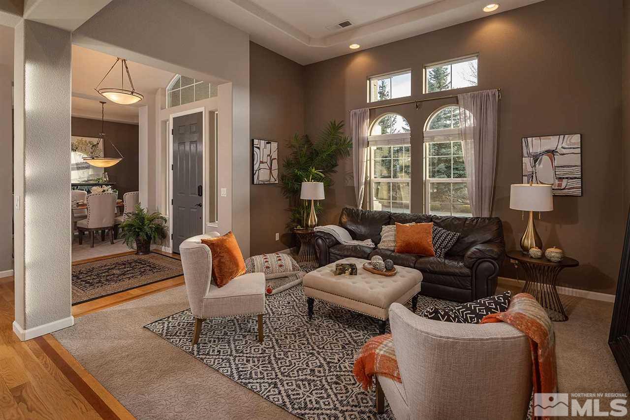 5278 North Elk River Road Reno, NV 89511 - Photo 20 of 30 a living room with furniture a lamp and a large window