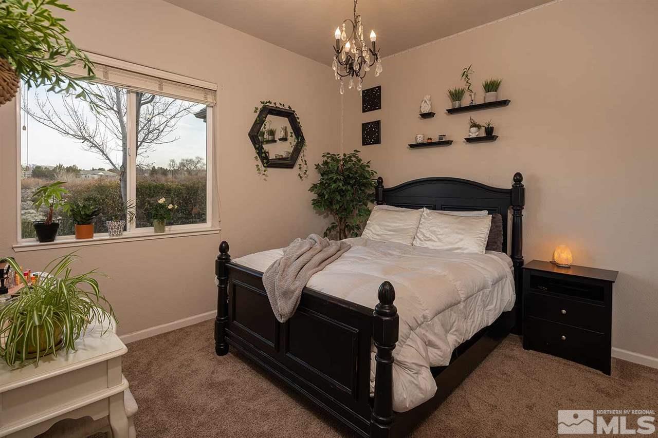 5278 North Elk River Road Reno, NV 89511 - Photo 27 of 30 a bed sitting in a spacious bedroom next to a window