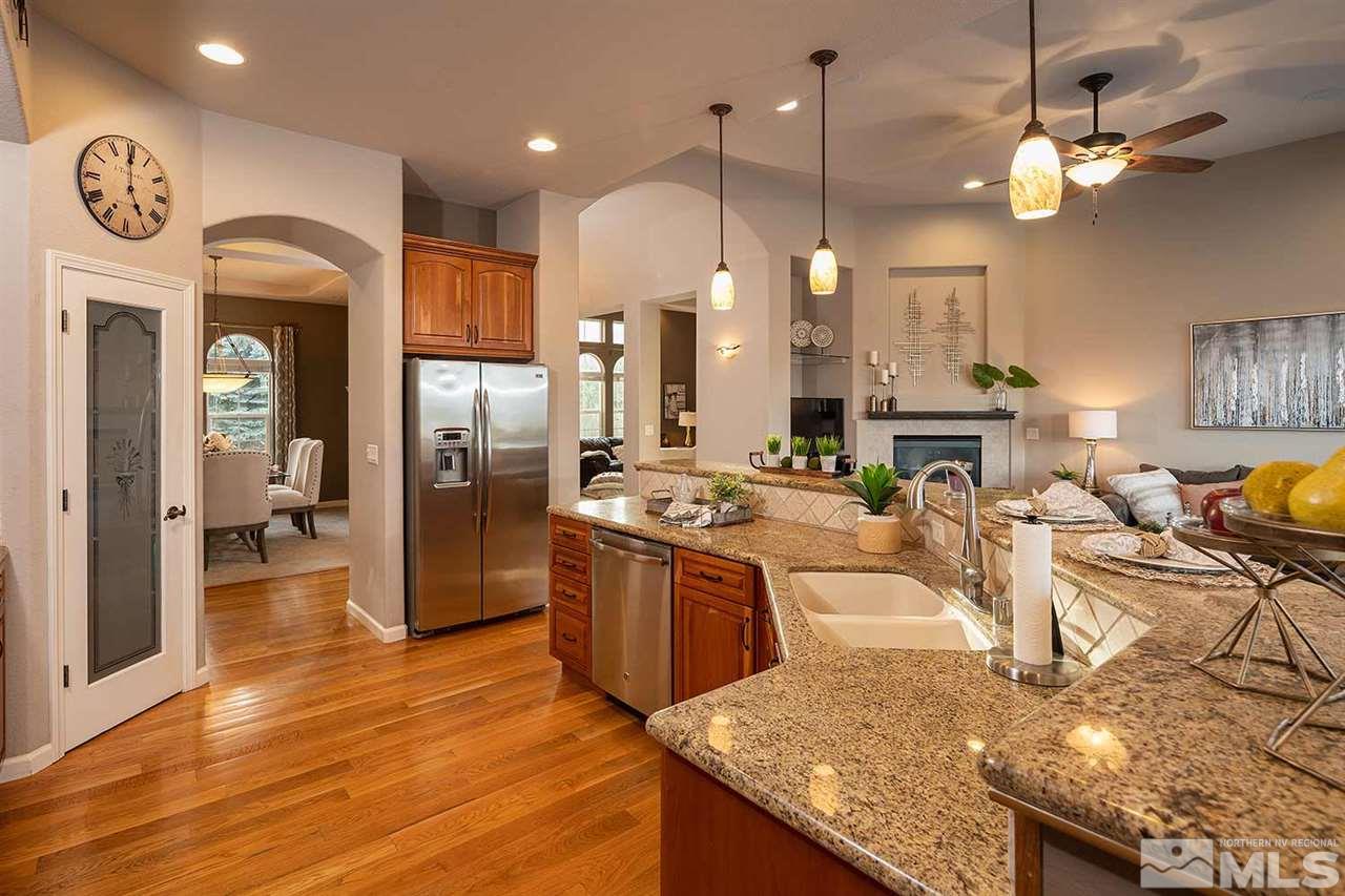 5278 North Elk River Road Reno, NV 89511 - Photo 5 of 30 a large kitchen with stainless steel appliances granite countertop a sink a stove and a wooden floors