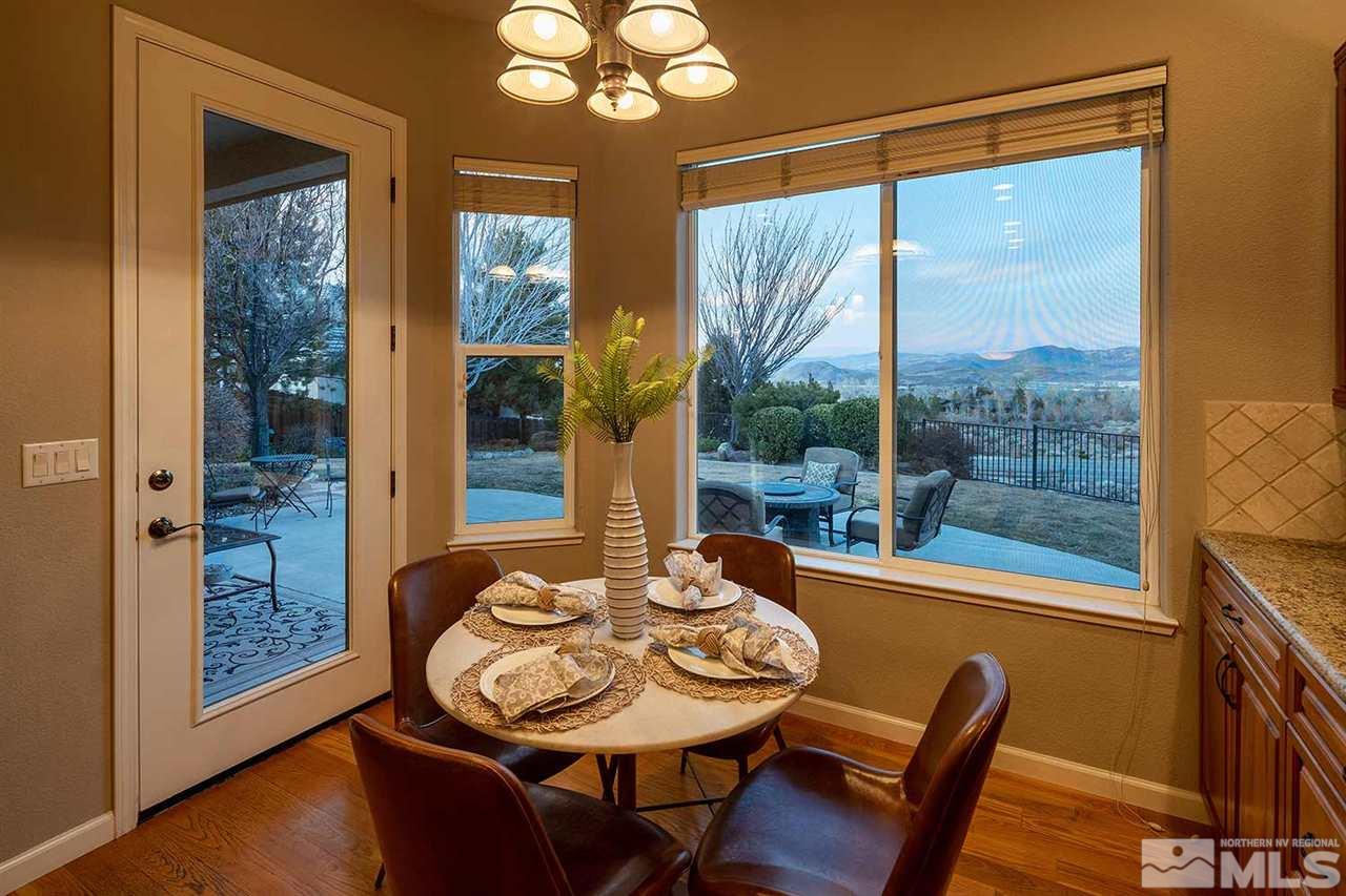5278 North Elk River Road Reno, NV 89511 - Photo 10 of 30 a view of a dining room with furniture wooden floor and chandelier