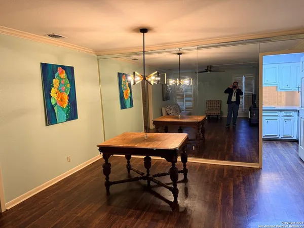 a dining room with furniture and wooden floor