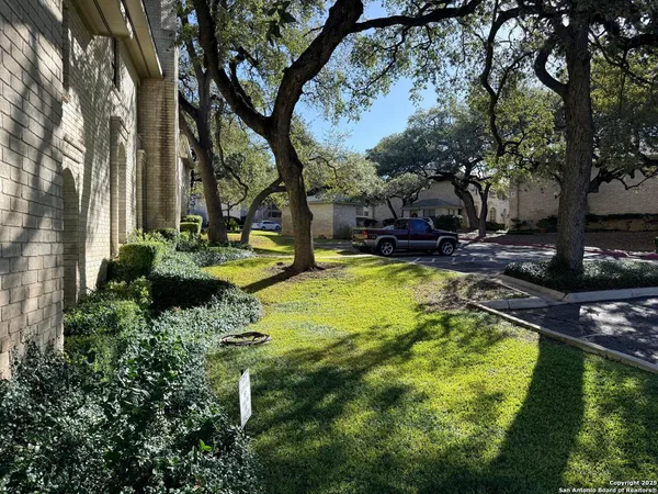 a view of a swimming pool with a patio and a yard