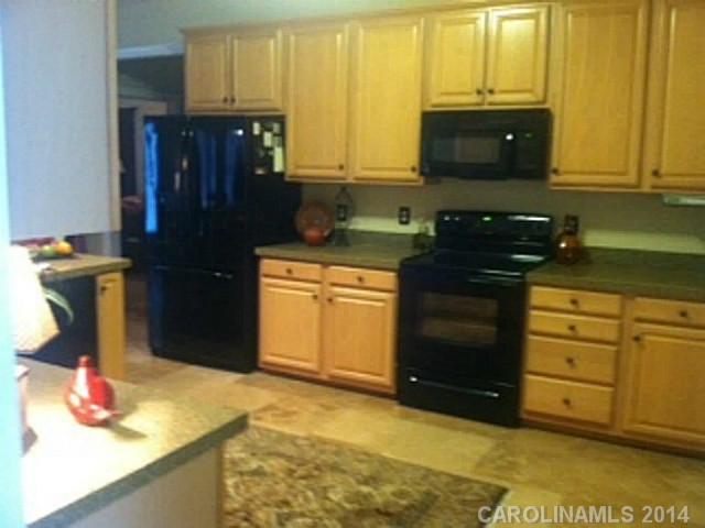 428 South Atlantic Drive Fort Mill, SC 29708 - Photo 8 of 16 a kitchen with stainless steel appliances granite countertop a stove a sink and a microwave