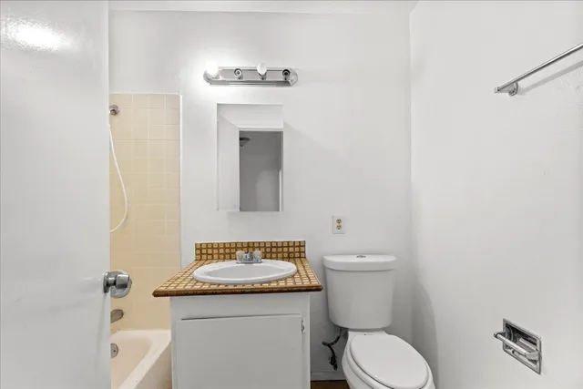 a bathroom with a toilet a sink and a mirror