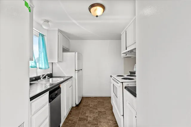 a kitchen with a sink stove and refrigerator