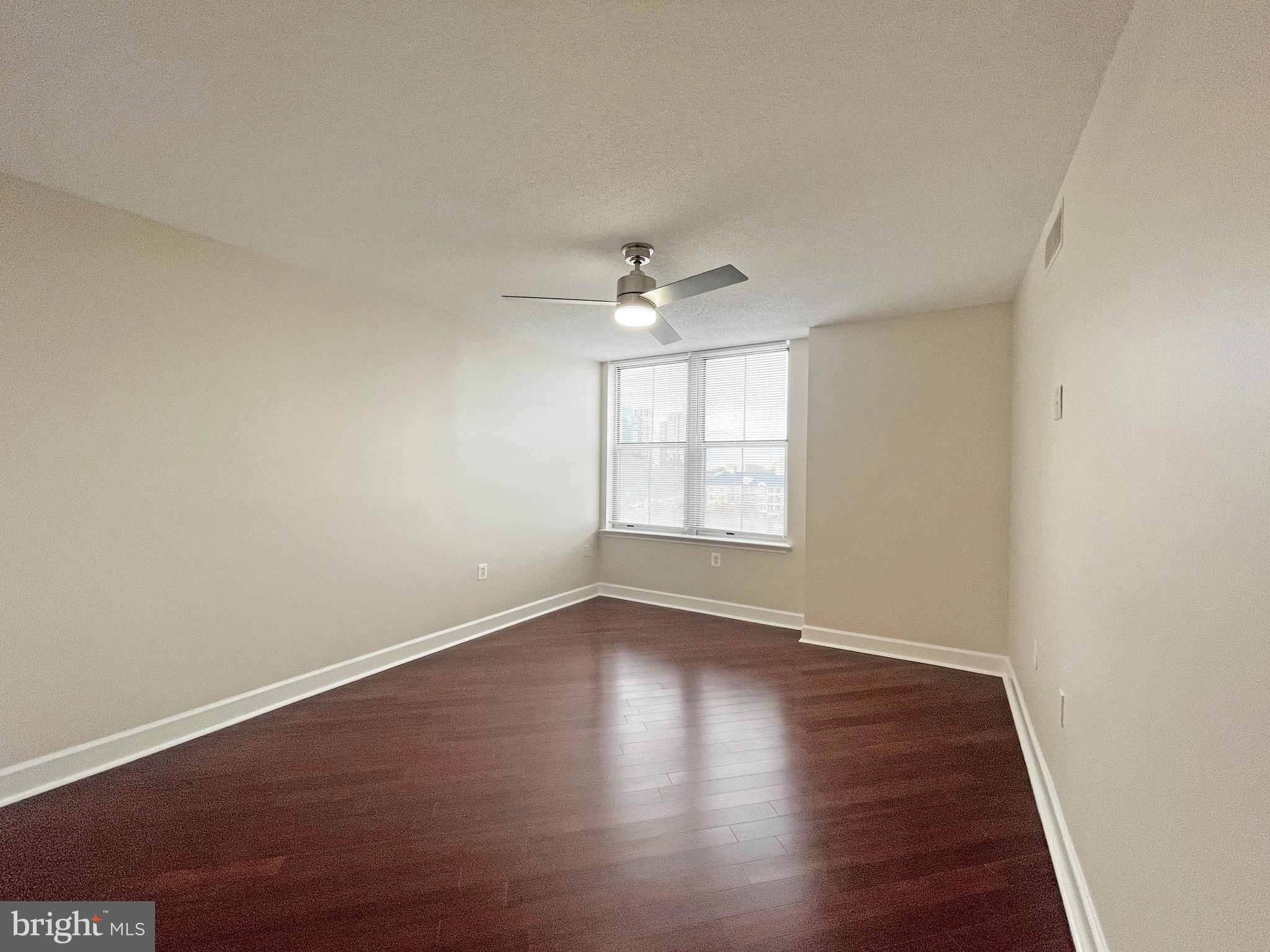 11800 Sunset Hills Road, Unit 722 Reston, VA 20190 - Photo 12 of 41 an empty room with wooden floor and windows