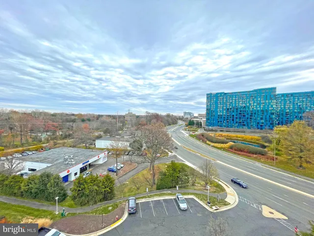 an aerial view of residential houses with outdoor space and swimming pool