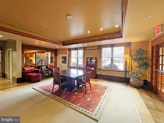 a living room with furniture a rug and a dining table