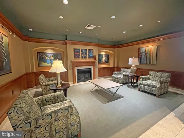 a living room with furniture a table and a potted plant