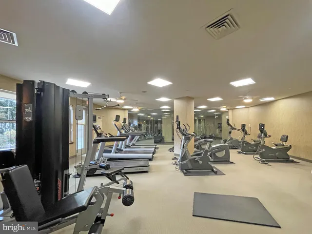 a room with gym equipment and mirror