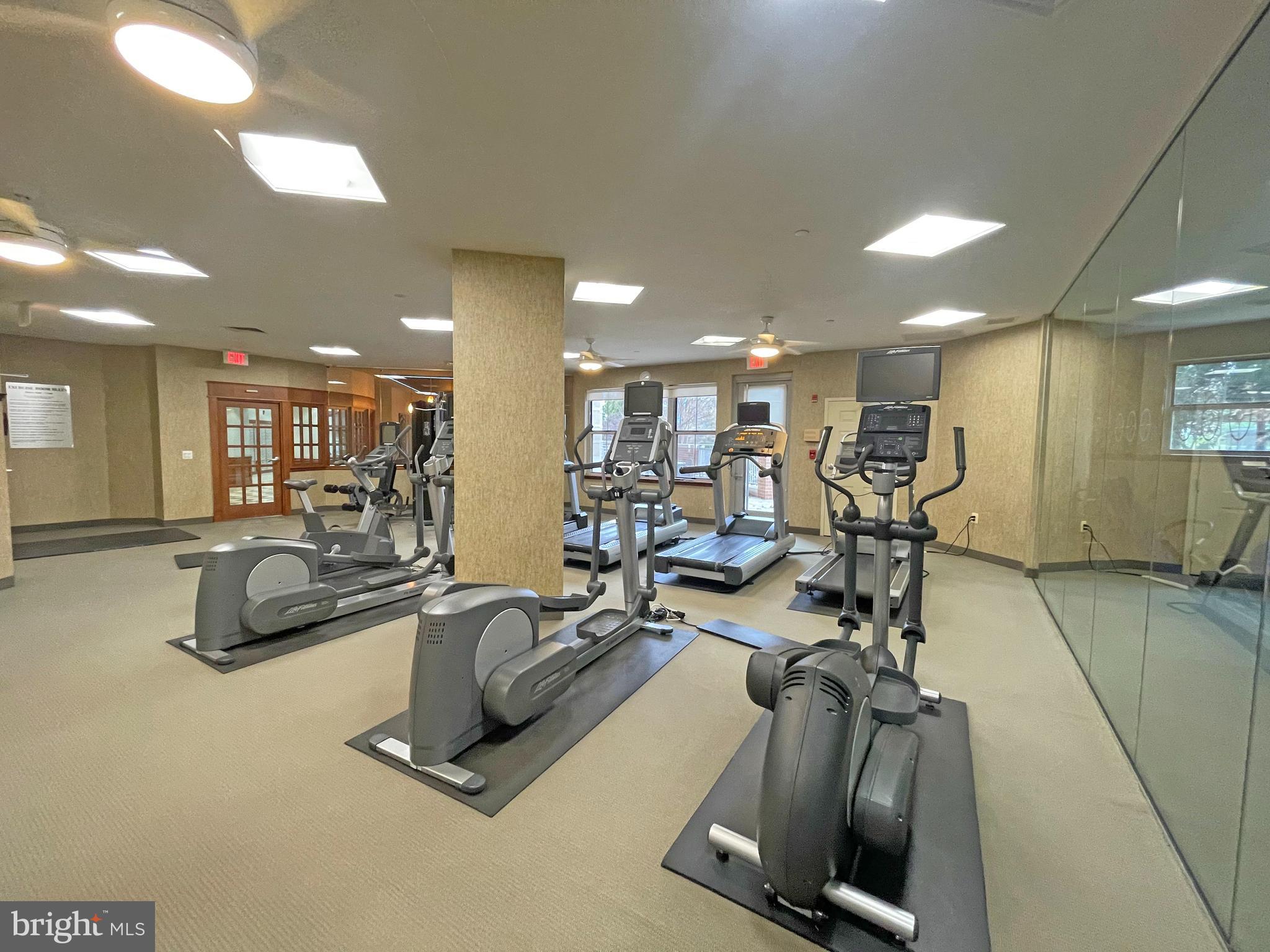 11800 Sunset Hills Road, Unit 722 Reston, VA 20190 - Photo 31 of 41 a room with gym equipment and mirror
