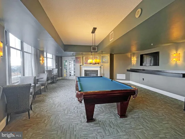 a living room with furniture and large windows