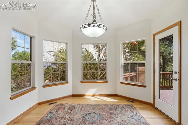a view of an room with wooden floor and windows