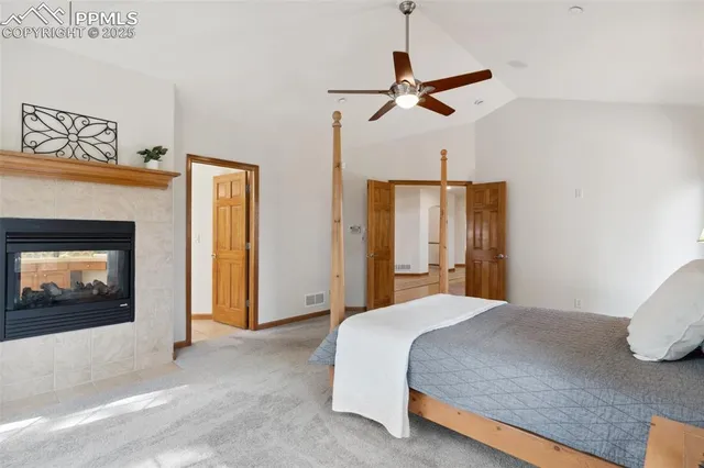 a bedroom with a bed and a fireplace