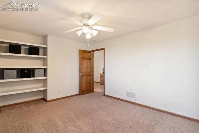 a view of an empty room with a fan
