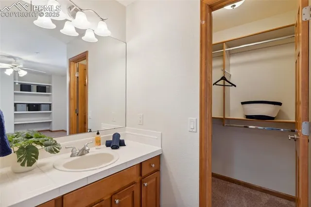 a bathroom with a sink vanity granite and a mirror