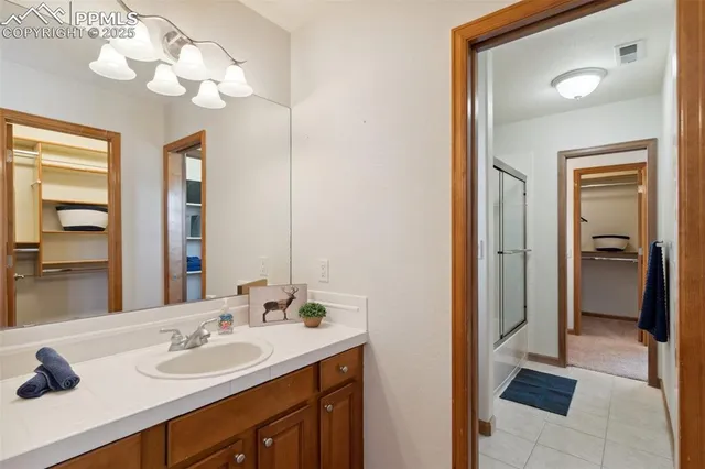 a bathroom with a sink vanity and a mirror