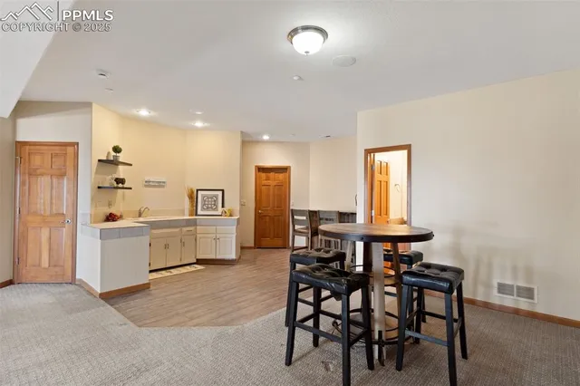 a kitchen with a table and chairs in it