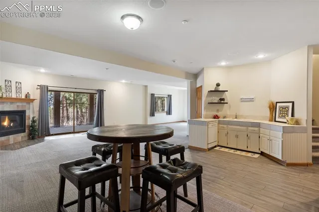 a kitchen with furniture and wooden floor