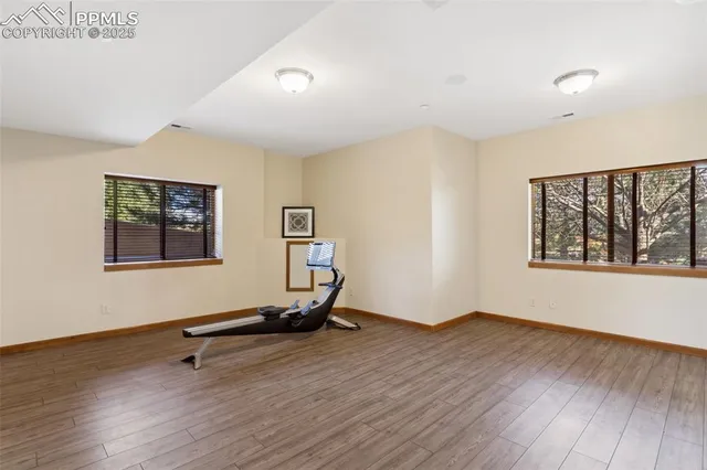 a view of a room with wooden floor and window