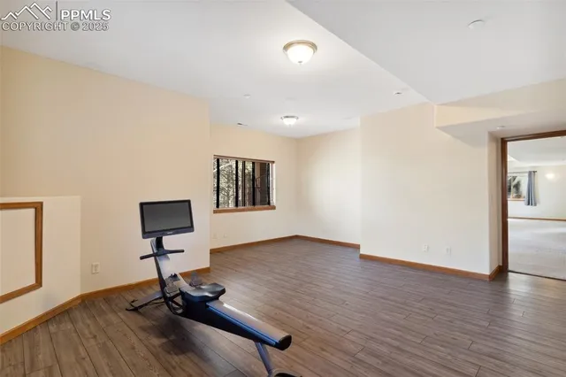 a view of workspace room with wooden floor and view