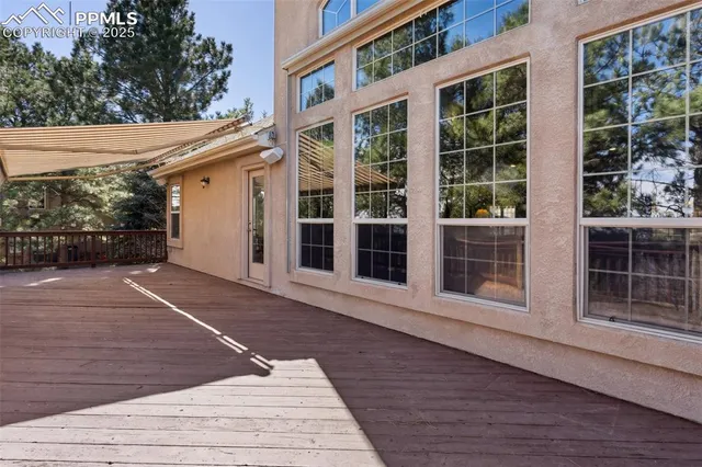 a view of a house with a large window and wooden floor
