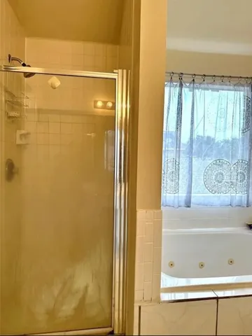 a white toilet sitting next to a shower