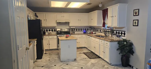 a kitchen with a sink stove and refrigerator