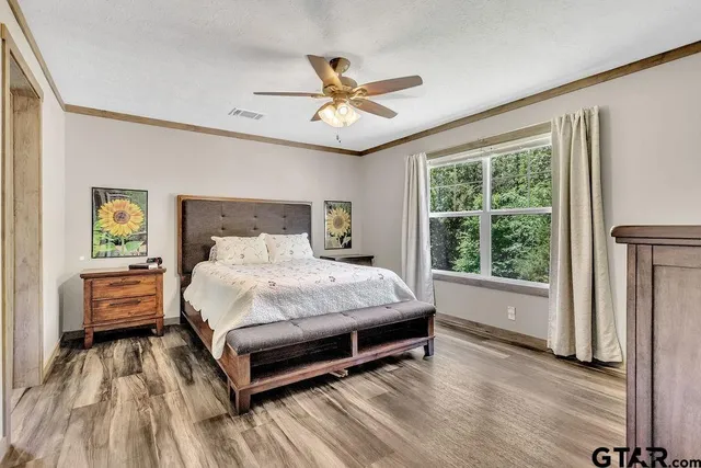 a bedroom with a bed and a large window with outer view