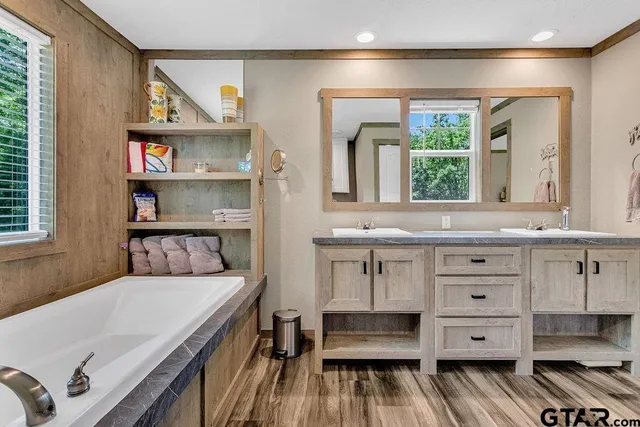 a view of cabinets a wooden floor and a window